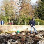 A Mapa Scotland member pressure blasting moss off the surface of the map